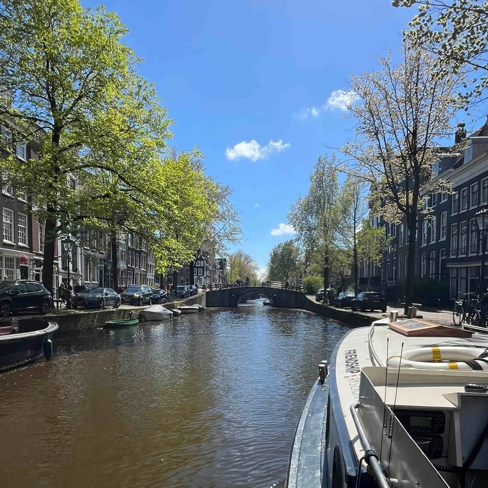 Amsterdam canal lined with historic houses on a two-week Europe itinerary