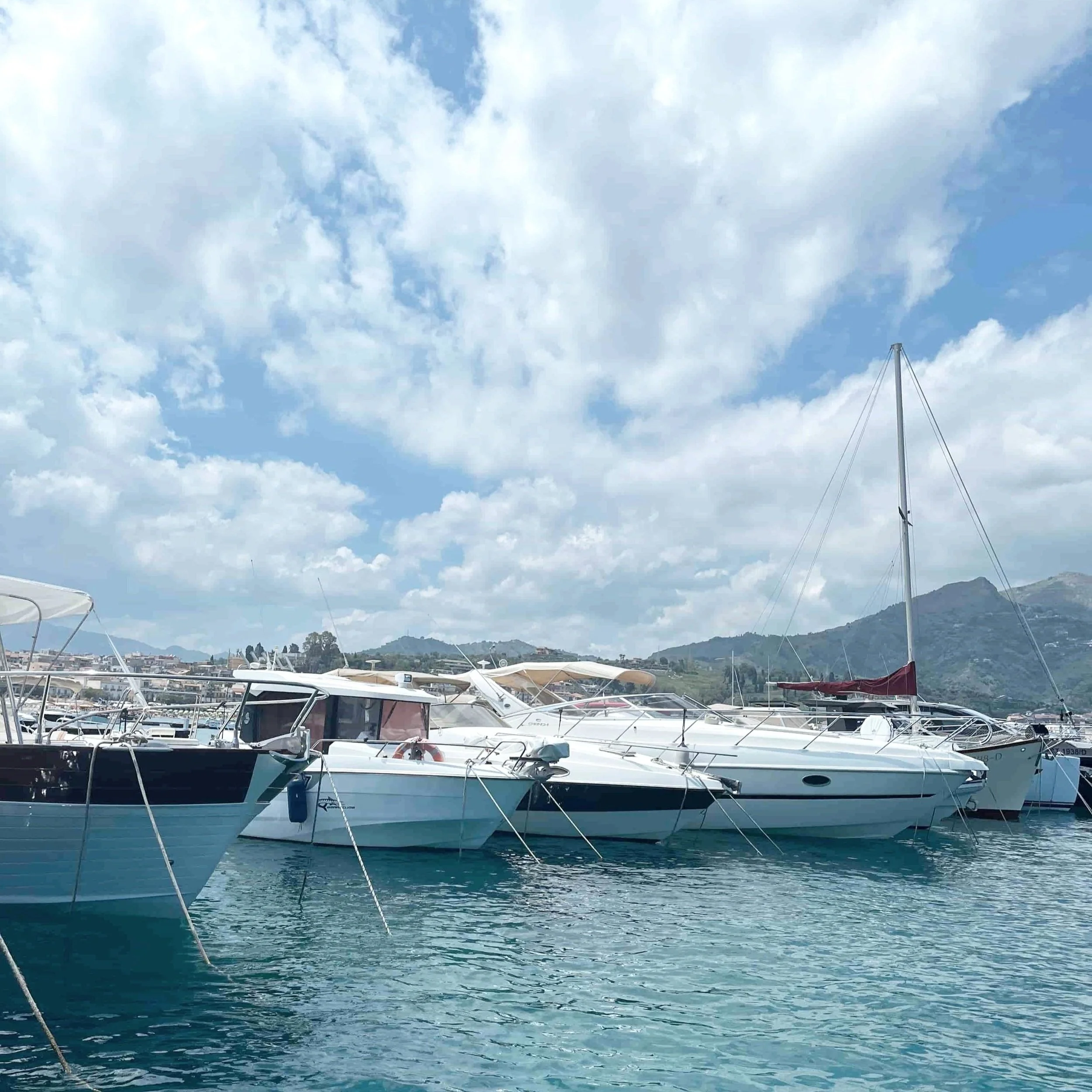 Boats docked at the Giardini Naxos port.