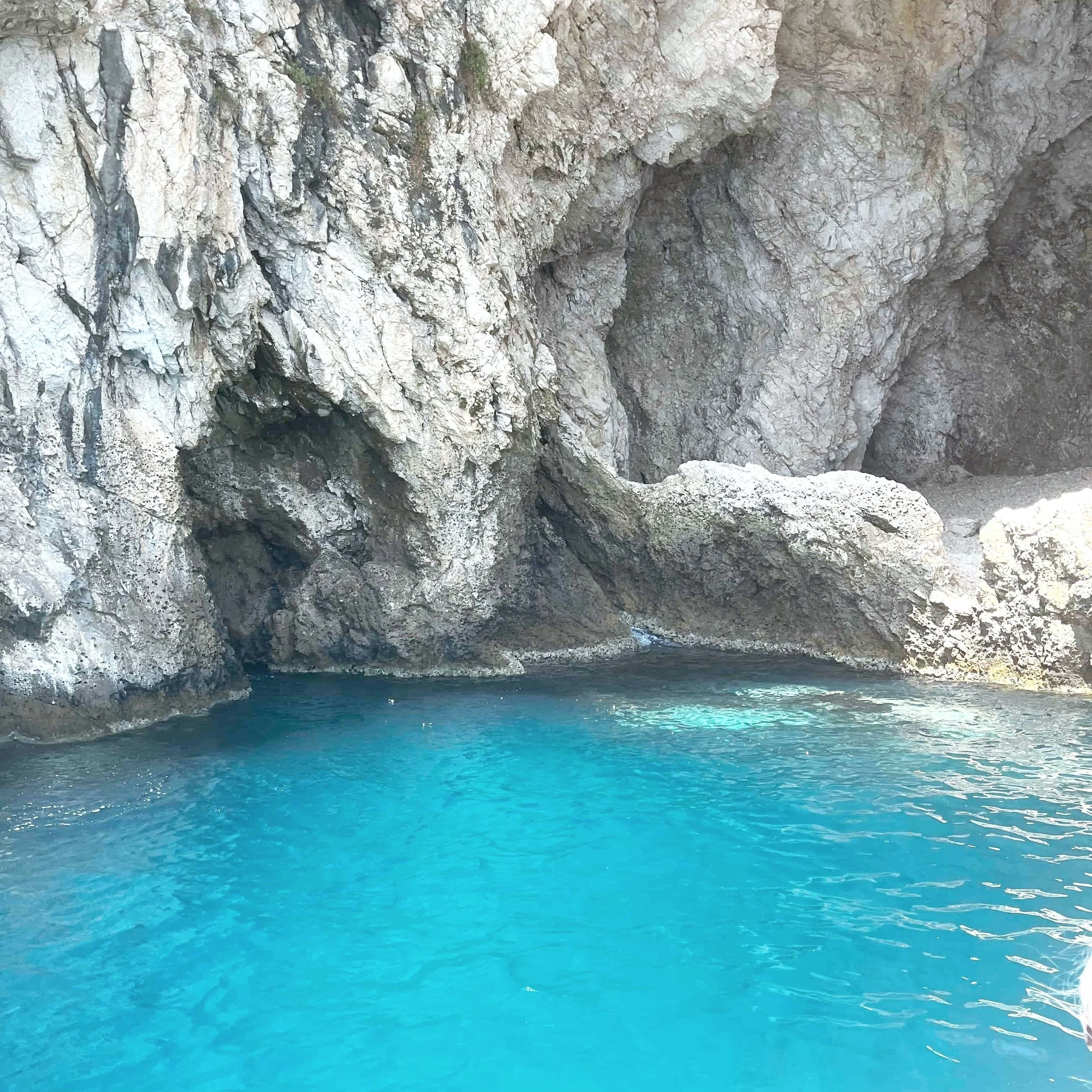 The bright blue waters inside the Grotta Azzurra