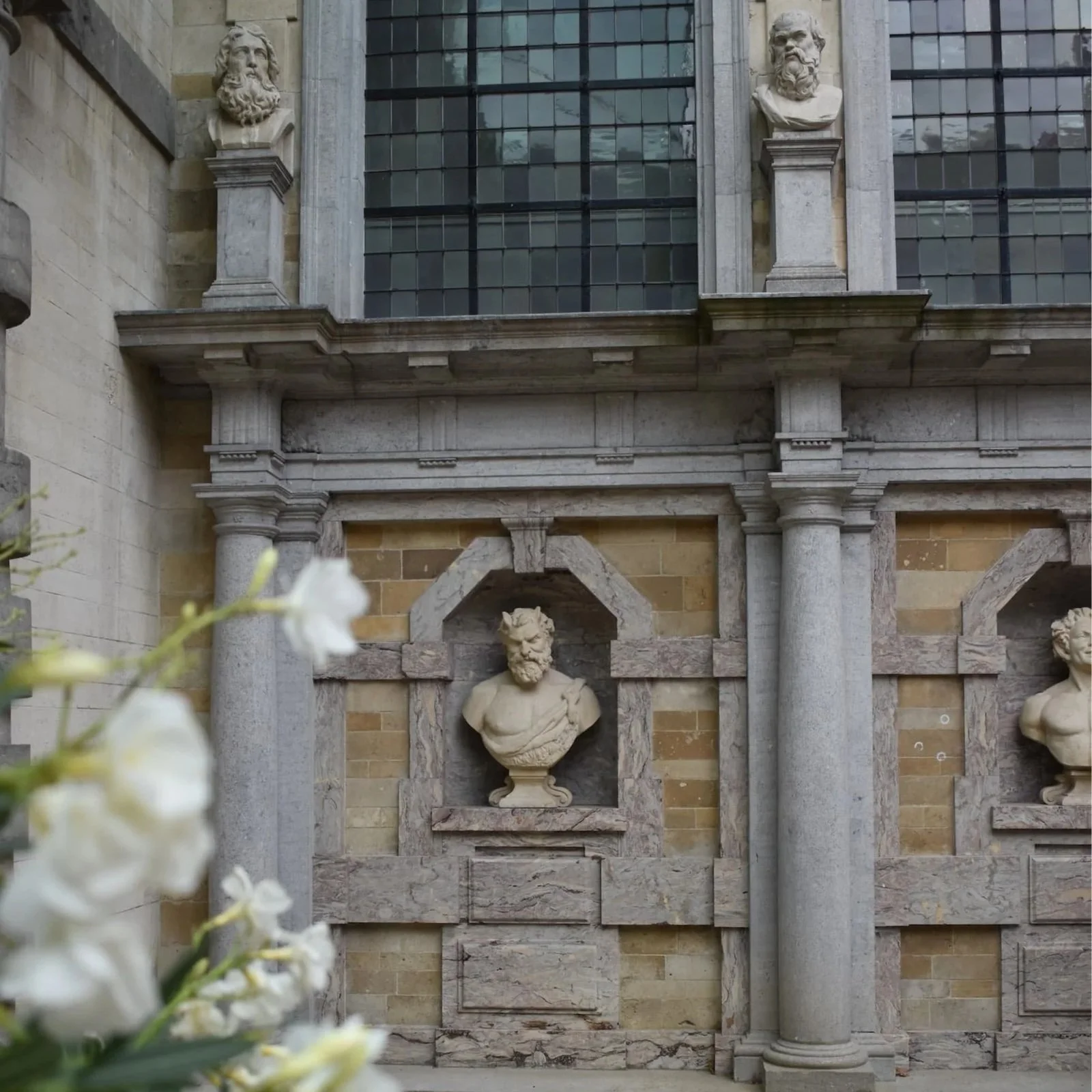 Admiring the bust statues and decorative elements in the garden at Rubenshuis, one of the best things to do for art lovers and garden fans..
