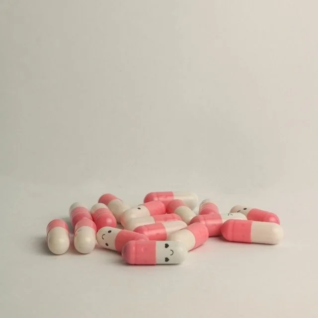 A pile of pink and white pills.