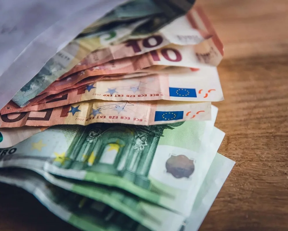 Euros and a card on a cafe table in Europe