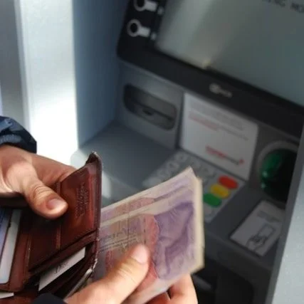 Cash being removed from an ATM.
